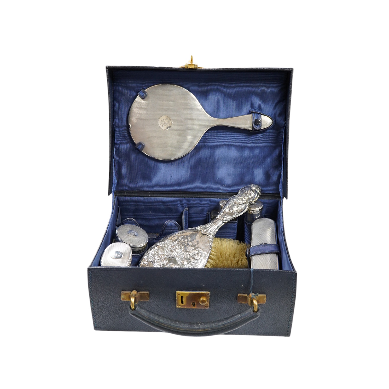A small George V silver mounted travelling toilet set, various dates, patterns and makers. Condition - poor to fair